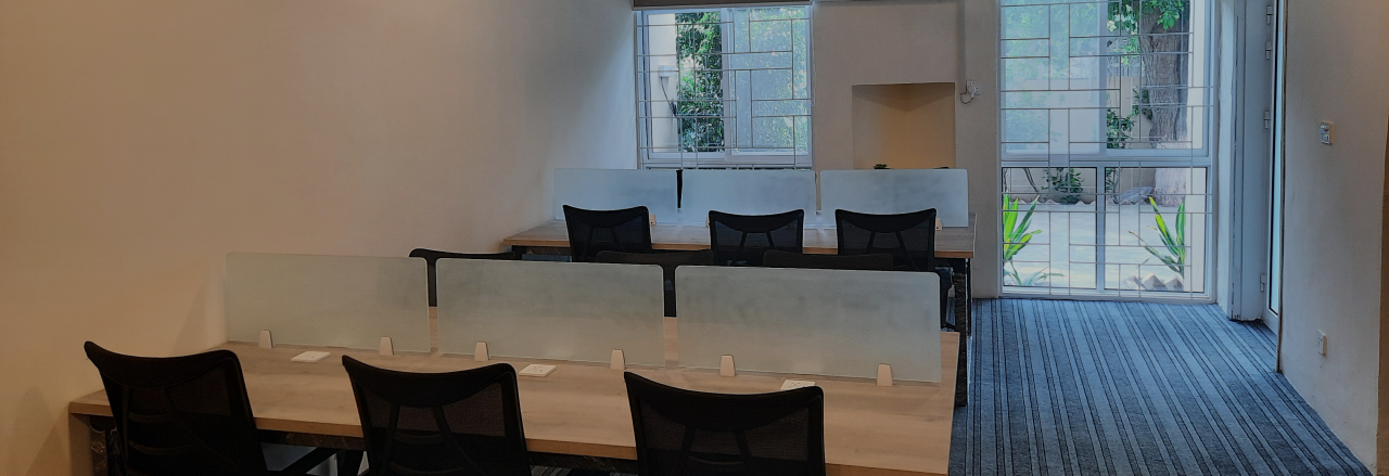 Shared desks with privacy dividers at WorkHive coworking space, Faisal Town Lahore