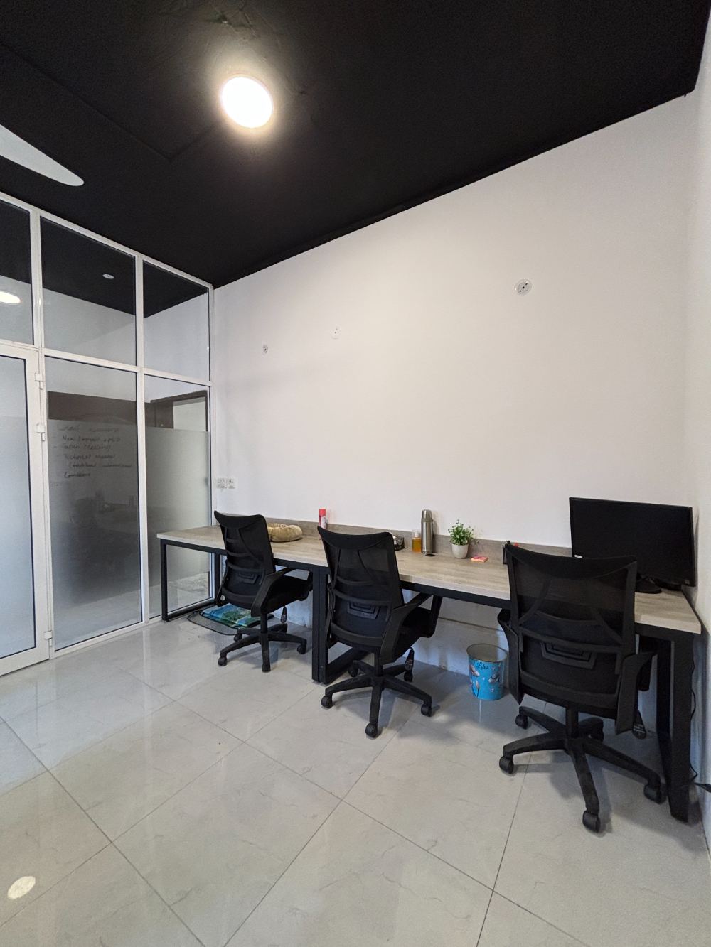 Quiet team room with desks and whiteboard at WorkHive